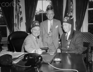 05 Sep 1945, Washington, DC, USA --- Wearing a Shrine fez he received from Imperial Shrine Potentate, William Woodfield, of San Francisco, President Truman shows his newest desk gadget. --- Image by © Bettmann/CORBIS